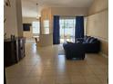 Open-concept living area with tile floors, neutral walls, and sliding glass doors leading to the pool at 779 Nectar Rd, Venice, FL 34293