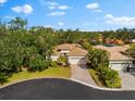 Single-Gathering home with tile roof, driveway, and landscaped yard in a residential neighborhood at 108 Corte Del Rosa, Venice, FL 34285