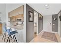 Modern kitchen with white countertops, stainless steel appliances, and breakfast bar at 109 Woodland Pl, Osprey, FL 34229