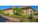 Side view of the home, showcasing the exterior walls, landscaping, and walkway at 12667 Sorrento Way, Bradenton, FL 34211