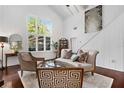 Bright living room with vaulted ceilings, large windows, and stylish furniture at 1656 Hillview St, Sarasota, FL 34239