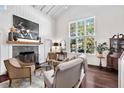 Inviting living room featuring a fireplace, large windows, and comfortable seating at 1656 Hillview St, Sarasota, FL 34239
