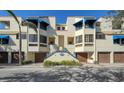 Full view of the building, showcasing architectural details and landscaping at 1904 Harbourside Dr # 204, Longboat Key, FL 34228