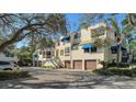 Front view of the building, showing multiple units and parking at 1904 Harbourside Dr # 204, Longboat Key, FL 34228