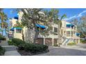 Side view of the building, highlighting the units and landscaping at 1904 Harbourside Dr # 204, Longboat Key, FL 34228