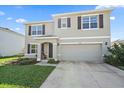 Two-story home featuring a two car garage, neutral colors, and well manicured lawn and covered front porch at 2819 Greenleaf Ter, Parrish, FL 34219