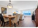 Elegant dining area with hardwood floors and water views at 4900 Gulf Of Mexico Dr # 205, Longboat Key, FL 34228