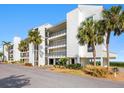 Condo building showcasing its modern facade and landscaping at 4900 Gulf Of Mexico Dr # 205, Longboat Key, FL 34228