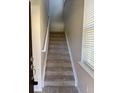 Carpeted stairs leading to the second floor at 5467 Soapstone Pl # 203, Sarasota, FL 34233