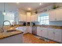Spacious kitchen with granite countertops and white cabinets at 7007 Holmes Blvd, Holmes Beach, FL 34217