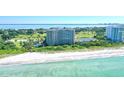 High-rise condominium on the beach with clear waters and a white sandy beach at 775 Longboat Club Rd # 708, Longboat Key, FL 34228