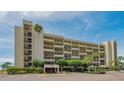 Condo building exterior with parking and landscaping at 1055 Gulf Of Mexico Dr # 504, Longboat Key, FL 34228