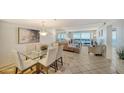 Bright dining area with glass table and ocean view at 1055 Gulf Of Mexico Dr # 504, Longboat Key, FL 34228