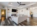 Cozy living room with a fireplace, built-in shelves, and wood-look floors at 1256 Napoleon Rd, North Port, FL 34288