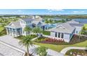 Community clubhouse with pool, lake, and lush landscaping, seen from an aerial perspective at 17942 Palmiste Dr, Bradenton, FL 34202