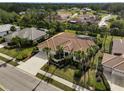 Property view showcasing house, landscaping, and neighborhood context at 2112 Calusa Lakes Blvd, Nokomis, FL 34275