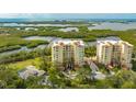 Aerial view showcasing luxurious condo building by the water at 385 N Point Rd # 404, Osprey, FL 34229