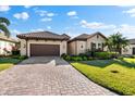 Beautiful single-story residence with a tile roof, brown garage door, and well-maintained lawn at 4740 Royal Dornoch Cir, Bradenton, FL 34211