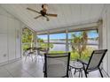 Screened porch with seating, ceiling fan, and tranquil water views at 6029 E Peppertree Way # 116, Sarasota, FL 34242