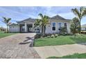 Charming home showcases landscaped greenery, a paver driveway, and meticulously maintained front yard at 8007 Nevis Run, Bradenton, FL 34202