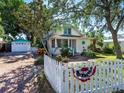 Quaint house with a white picket fence and driveway at 2724 Ashton Rd, Sarasota, FL 34231