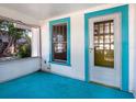 Bright porch with blue painted floors and screened windows at 2724 Ashton Rd, Sarasota, FL 34231