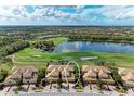 Beautiful aerial view of a golf course community with tile roofs and lush landscaping at 318 Winding Brook Ln # 104, Bradenton, FL 34212