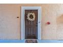Front door with a wreath, welcome mat and keyless entry at 4106 Central Sarasota Pkwy # 1013, Sarasota, FL 34238