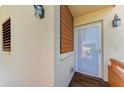 Front entrance with wood-paneled accent wall and white door at 141 Wild Palm Dr, Bradenton, FL 34210