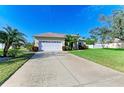 Landscaped yard with a two-car garage and spacious driveway at 1605 21St W Ave, Palmetto, FL 34221