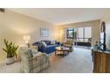 Bright living room with comfy seating and sliding door to patio at 3267 Beneva Rd # 103, Sarasota, FL 34232