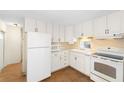 Clean, white kitchen with ample cabinetry and modern appliances at 3403 Overcup Oak Ter, Sarasota, FL 34237