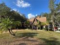 House with a-frame design, surrounded by trees at 3455 Gardenia St, Sarasota, FL 34237
