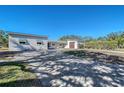 Updated home exterior, featuring a paver driveway at 5072 Higel Ave, Sarasota, FL 34242