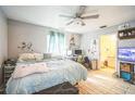 Main bedroom with a king-size bed, ceiling fan, and an ensuite bathroom at 5815 114Th N Ter, Pinellas Park, FL 33782