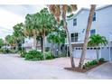 Row of beach homes with tropical landscaping and private driveways at 6250 Holmes Blvd # 32, Holmes Beach, FL 34217