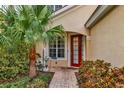 Inviting front entry with red door and brick pathway at 7416 Birds Eye Ter, Bradenton, FL 34203