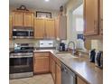 Well-equipped kitchen featuring wood cabinets and stainless steel appliances at 7416 Birds Eye Ter, Bradenton, FL 34203