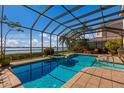 Inviting screened pool and spa overlooking the water at 805 Riviera Dunes Way, Palmetto, FL 34221