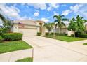 Charming single Gathering home with a two-car garage, mature landscaping, and a well-manicured lawn at 8412 Whispering Woods Ct, Lakewood Ranch, FL 34202