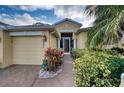 Inviting exterior of a single-story home with landscaped walkway at 9351 Raes Creek Pl, Palmetto, FL 34221