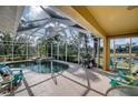 Relaxing screened-in pool area with a spa and outdoor kitchen at 9351 Raes Creek Pl, Palmetto, FL 34221