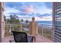 Relaxing balcony with ocean view and comfortable seating at 4125 Gulf Of Mexico Dr # S201, Longboat Key, FL 34228