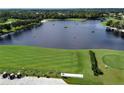 Aerial view of a driving range with lake and golfers at 4566 Samoset Dr, Sarasota, FL 34241