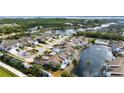 Aerial view of condo community with water features, manicured landscaping, swimming pool and assigned parking at 502 Woodstork Cir, Bradenton, FL 34209