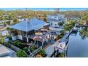 Waterfront property with a boat lift, outdoor seating, and lush landscaping for enjoying the outdoor views at 521 Cummings St, Sarasota, FL 34242