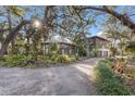 Mid-century modern home nestled among mature trees and lush landscaping at 5519 17Th W St, Palmetto, FL 34221