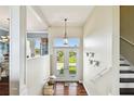 Bright entryway with hardwood floors, double doors, and a staircase at 5531 2Nd Avenue W Cir, Palmetto, FL 34221