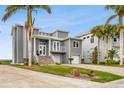 Gray house with stone driveway and palm trees in front at 5531 2Nd Avenue W Cir, Palmetto, FL 34221