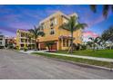 Luxury waterfront home with three-car garage and palm trees at 6418 Margarita Shores Ln, Apollo Beach, FL 33572